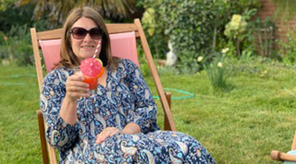 A Woman posing with a Mocktail at garden