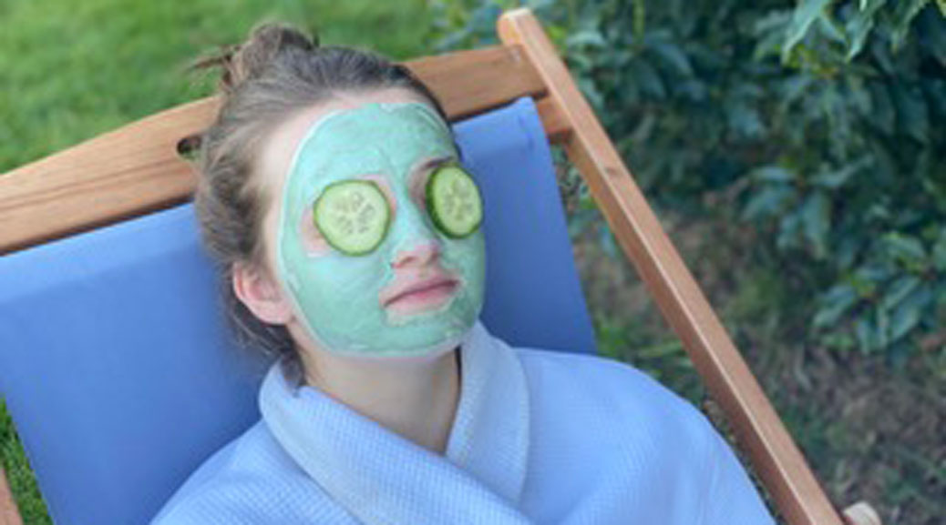 a woman with a face pack in backyard