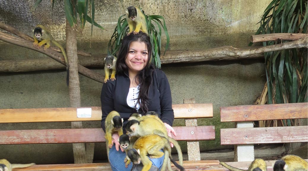Girl playing with Squirrel Monkeys in Capetown, South Africa
