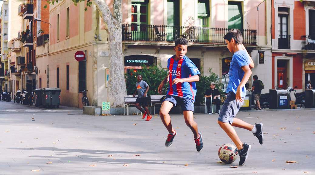 Kids playing football at streets