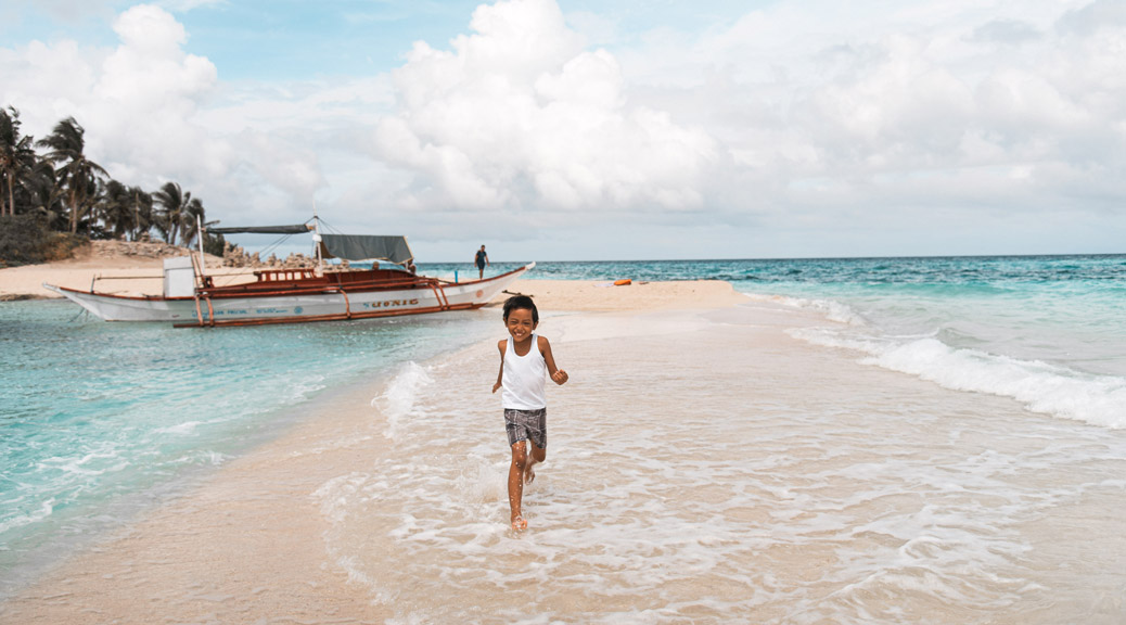 A Kid running in a beach