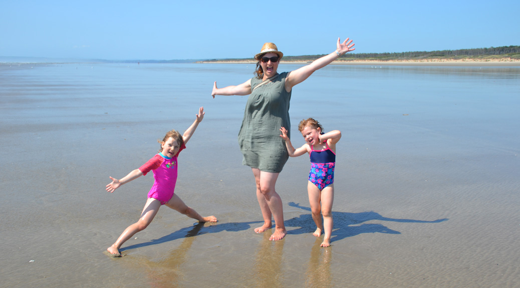 Travel Blogger with her kids at a beach