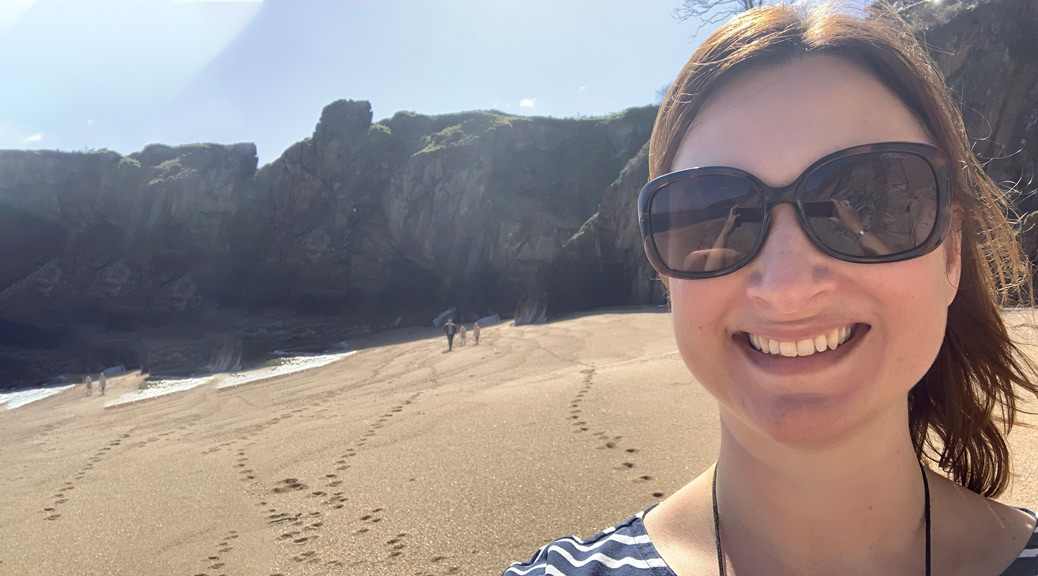 Selfie of a Female Travel blogger showing the hills and beach view