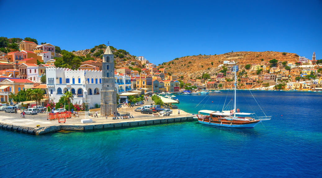 View on Greek sea Simy island harbor port, classical ship yachts, houses on island hills, tourists Aegean Sea bay, Santorini