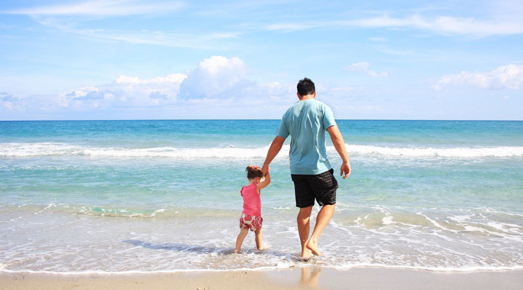 A Father with her kid at a beach