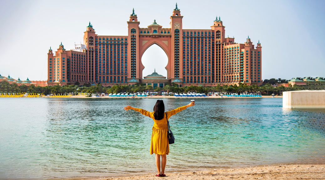 Female tourist in front of the famous hotel Atlantis, Dubai