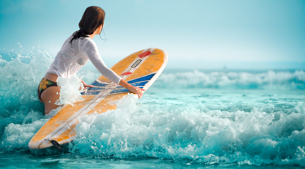 Surf girl with surfboard on Beach
