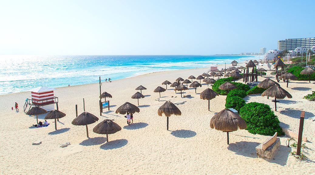 Hay-umbrellas placed on the Beautiful beach on the Caribbean coast on a clear weather