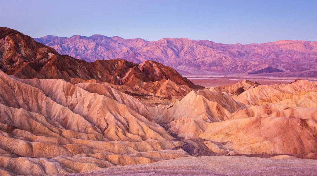 Beautiful view of Death Valley with sand dunes and sunset with blue sky.