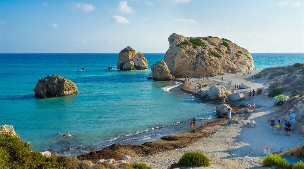 people enjoying between rock of Aphrodite on beautiful beach and sea bay