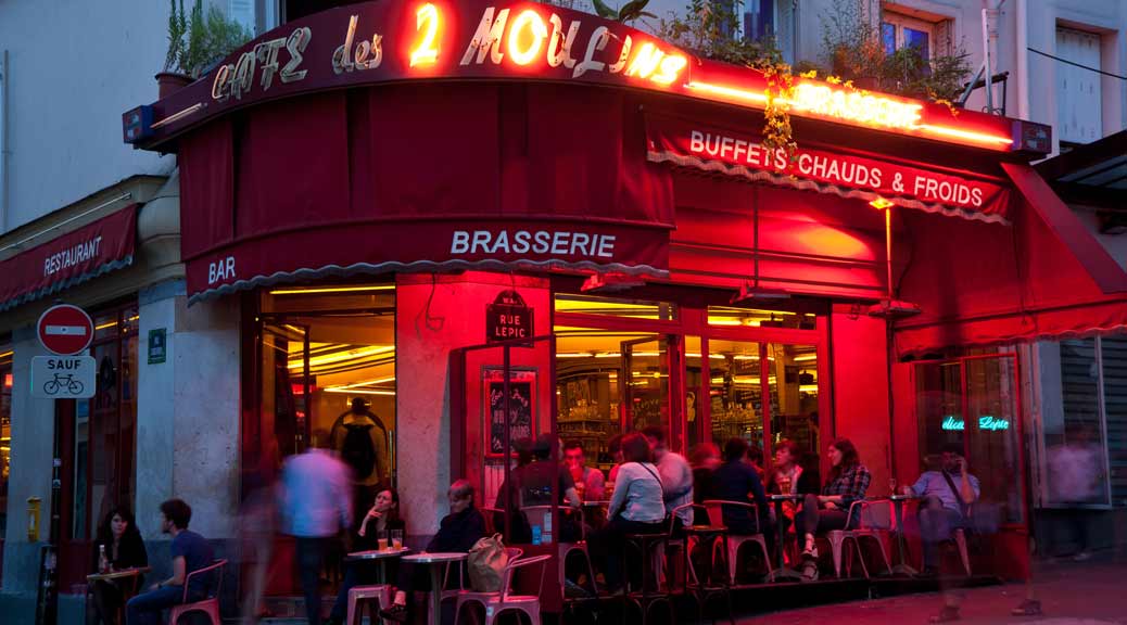people enjoying coffee in a famous coffee house Cafe des 2 Moulins in paris
