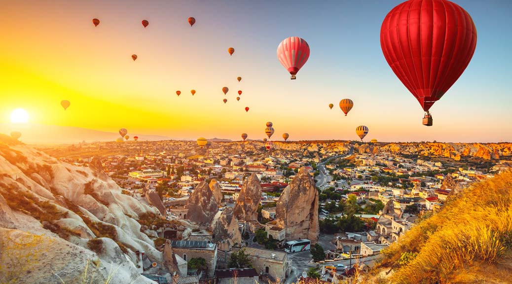 sunrise at Turkish town of Cappadocia with hot air balloons 