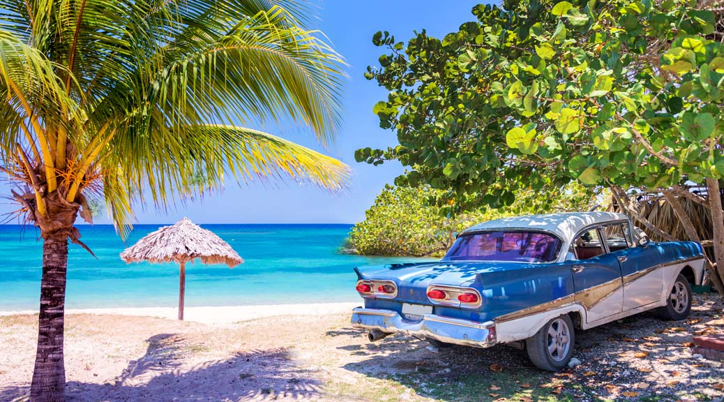  Vintage american oldtimer car parked on a beach in Cuba