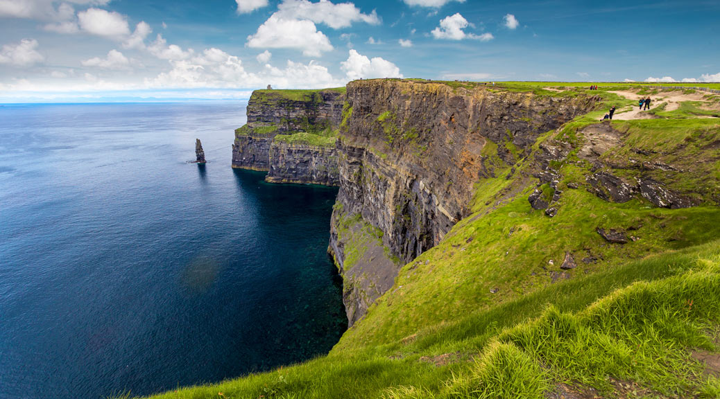 The panoramic view of beautiful scenic irish landscape with blue sea water and sky, Ireland.