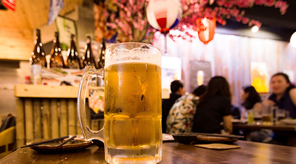  glass of beer on the wooden table in Japanese restaurant vintage style
