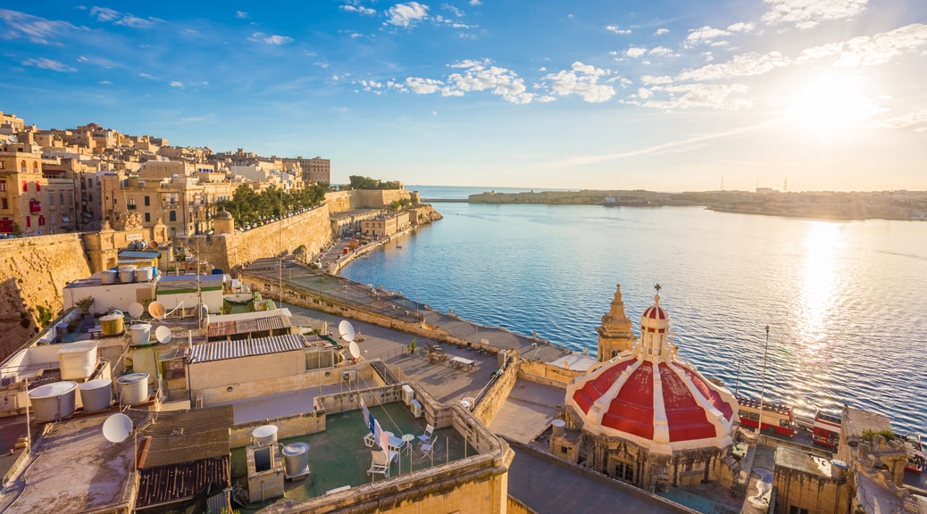 Sunrise at the Grand Harbour of Malta with the ancient walls of Valletta