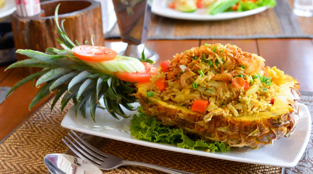 vegan thai pineapple fried rice served on a pineapple