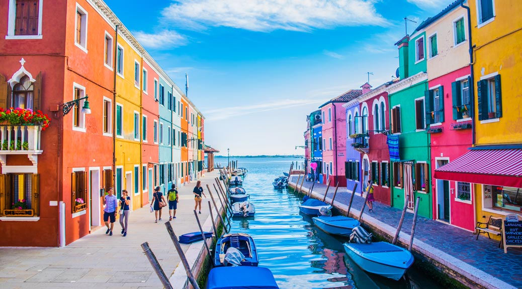 colourful houses surrounded by water canals in venice